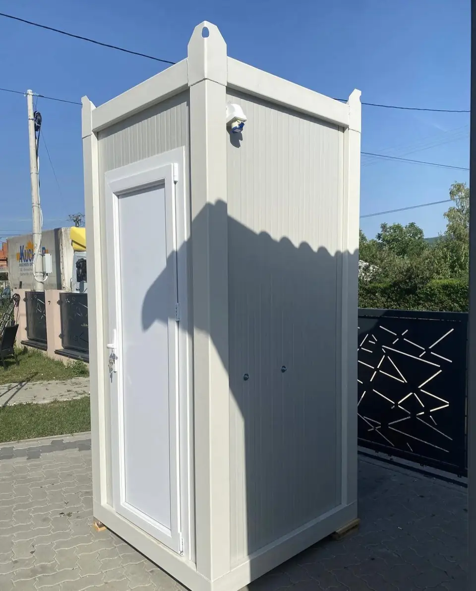 White single-stall deluxe flushing restroom unit with a paneled door