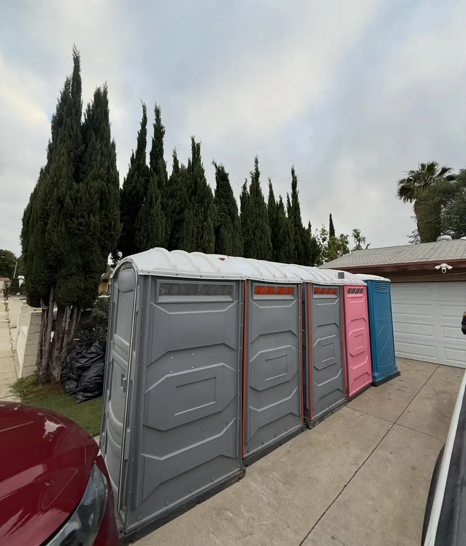 Porta potties strapped to a flatbed delivery trailer