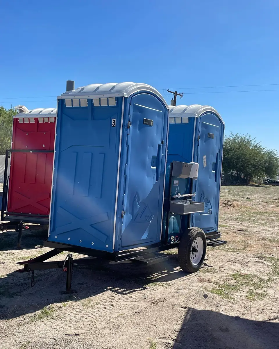 Blue porta potties loaded on a delivery trailer ready for a same-day route