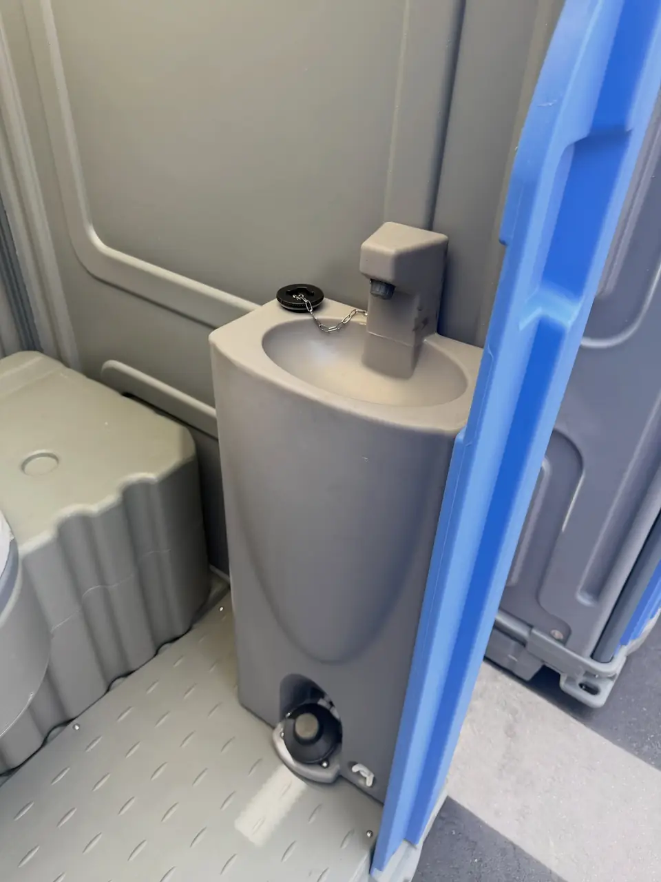 Spacious porta potty interior with a molded hand sanitizer stand